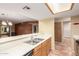 A kitchen counter with a sink area, opening to a dining and living space at 1021 S Greenfield Rd # 1165, Mesa, AZ 85206