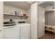 Bright laundry room includes washer, dryer, and built-in shelving for convenient storage at 1021 S Greenfield Rd # 1165, Mesa, AZ 85206