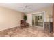 A sun room with an armchair, ceiling fan, tile flooring, and sliding glass doors at 1021 S Greenfield Rd # 1165, Mesa, AZ 85206