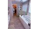 Relaxing bathroom featuring a soaking tub and glass-enclosed shower, creating a spa-like retreat at 10335 W Pima St, Tolleson, AZ 85353