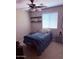 Comfortable bedroom with ceiling fan and natural light, creating a serene and cozy environment at 10335 W Pima St, Tolleson, AZ 85353