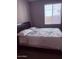 Bedroom with upholstered headboard and natural light at 10335 W Pima St, Tolleson, AZ 85353