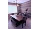 Dining room with wood accent wall, large window, modern chandelier, and tile flooring at 10335 W Pima St, Tolleson, AZ 85353