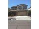 Two-story home with neutral paint, two-car garage, and low-maintenance landscaping at 10335 W Pima St, Tolleson, AZ 85353