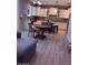 Open kitchen with island, white cabinets, stainless appliances, and tile flooring at 10335 W Pima St, Tolleson, AZ 85353