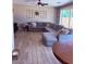 Living room with sectional sofa, ceiling fan, and tile flooring at 10335 W Pima St, Tolleson, AZ 85353