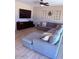 Living room with sectional sofa, ceiling fan, and tile flooring at 10335 W Pima St, Tolleson, AZ 85353