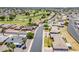 An aerial view of a Sun City neighborhood with single Gathering homes located next to a golf course at 11135 W Cameo Dr, Sun City, AZ 85351