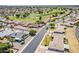 An aerial view of a Sun City neighborhood with single Gathering homes located next to a golf course at 11135 W Cameo Dr, Sun City, AZ 85351