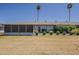 Spacious backyard with an enclosed patio and palm trees creating a tranquil setting at 11135 W Cameo Dr, Sun City, AZ 85351