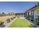 Lush backyard featuring decorative potted plants and a screened-in patio for outdoor enjoyment at 11135 W Cameo Dr, Sun City, AZ 85351