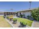 Well-maintained backyard with manicured landscaping and a screened-in patio area at 11135 W Cameo Dr, Sun City, AZ 85351