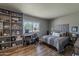 Comfortable bedroom with a stylish accent wall, a built-in bookcase and a bright window at 11135 W Cameo Dr, Sun City, AZ 85351