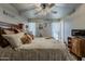 Bedroom with natural light, ceiling fan, and well decorated furnishings at 11135 W Cameo Dr, Sun City, AZ 85351