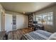Bright bedroom with ample storage, a dedicated workspace, and a large window showcasing the neighborhood at 11135 W Cameo Dr, Sun City, AZ 85351