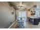 Open dining area with modern table, pendant lights, breakfast bar, and backyard access at 11135 W Cameo Dr, Sun City, AZ 85351