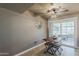 A dining table with seating overlooks an outdoor patio area, ideal for enjoying meals with a view at 11135 W Cameo Dr, Sun City, AZ 85351