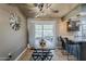 Inviting dining room with modern lighting, stylish furniture, and views of the outdoor living space at 11135 W Cameo Dr, Sun City, AZ 85351