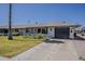 Charming single-story home with a well-manicured lawn, attached garage, and desert landscaping at 11135 W Cameo Dr, Sun City, AZ 85351