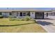 Attractive, single-story home featuring a driveway, manicured lawn, desert landscaping, and an attached garage at 11135 W Cameo Dr, Sun City, AZ 85351
