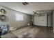 Clean garage with white walls, and a door to backyard and a garage door at 11135 W Cameo Dr, Sun City, AZ 85351