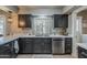 A kitchen showcases dark wood cabinets, stone countertops, and stainless steel appliances at 11135 W Cameo Dr, Sun City, AZ 85351
