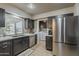 Modern kitchen featuring stainless steel appliances, sleek cabinetry, and ample counter space at 11135 W Cameo Dr, Sun City, AZ 85351