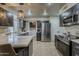 This modern kitchen features stainless steel appliances, stone countertops, and an open design at 11135 W Cameo Dr, Sun City, AZ 85351