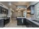 The kitchen showcases modern appliances, sleek countertops, and a seamless flow to the dining area at 11135 W Cameo Dr, Sun City, AZ 85351