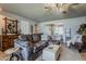 Cozy living room with tile floors, comfortable seating, a ceiling fan, and an open floor plan at 11135 W Cameo Dr, Sun City, AZ 85351