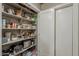 Well-organized pantry with shelving, providing ample storage for food and kitchen essentials at 11135 W Cameo Dr, Sun City, AZ 85351