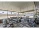 Enclosed patio featuring comfortable seating, a ceiling fan, and a relaxing outdoor space at 11135 W Cameo Dr, Sun City, AZ 85351