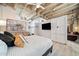 Spacious bedroom featuring concrete ceilings, an entertainment center, and modern decor at 114 W Adams St # 202, Phoenix, AZ 85003