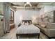 Bright bedroom featuring a concrete ceiling, exposed brick, and modern decor at 114 W Adams St # 202, Phoenix, AZ 85003