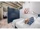 Comfortable bedroom featuring exposed concrete ceilings, custom closets, modern decor, and a queen-size bed at 114 W Adams St # 202, Phoenix, AZ 85003