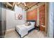 Industrial bedroom showcases exposed brick wall, concrete ceilings, modern decor, and queen-size bed at 114 W Adams St # 202, Phoenix, AZ 85003
