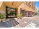 Building entrance featuring glass doors, potted plants, and sidewalk details showcasing the building at 114 W Adams St # 202, Phoenix, AZ 85003