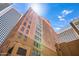 Stunning low-angle view of a building, emphasizing its height, architecture, and the blue sky at 114 W Adams St # 202, Phoenix, AZ 85003