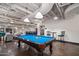 Bright game room with blue billiard table, pendant lighting, and seating at 114 W Adams St # 202, Phoenix, AZ 85003