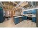 Open kitchen with blue cabinets, stainless appliances, and breakfast bar with seating area at 114 W Adams St # 202, Phoenix, AZ 85003