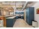 Contemporary kitchen boasts blue cabinets, stainless appliances, and breakfast bar with seating at 114 W Adams St # 202, Phoenix, AZ 85003