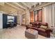 Spacious living room with exposed brick, concrete ceilings, and comfortable leather seating at 114 W Adams St # 202, Phoenix, AZ 85003