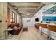 Comfortable living area with open layout, exposed brick, industrial ceilings, and connected bar seating at 114 W Adams St # 202, Phoenix, AZ 85003