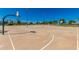 Outdoor basketball court with multiple hoops, surrounded by mature trees and well-maintained landscaping at 1201 E Campbell Ave, Gilbert, AZ 85234