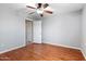 Bedroom with a ceiling fan and light hardwood floors offers a neutral color pallete at 1201 E Campbell Ave, Gilbert, AZ 85234