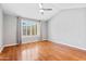 Light-filled bedroom featuring wood floors, a ceiling fan, and window shutters at 1201 E Campbell Ave, Gilbert, AZ 85234