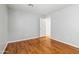 Empty bedroom with light hardwood floors, a neutral paint color, and white trim at 1201 E Campbell Ave, Gilbert, AZ 85234