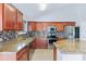 Well-appointed kitchen featuring tile flooring, stainless steel appliances and granite countertops at 1201 E Campbell Ave, Gilbert, AZ 85234