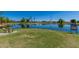 Scenic community pond with mature trees and open green space for residents to enjoy at 1201 E Campbell Ave, Gilbert, AZ 85234