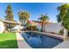 Backyard pool with palm tree, privacy wall, outdoor seating under pergola and green turf at 1201 E Campbell Ave, Gilbert, AZ 85234
